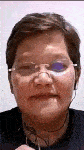 a close up of a woman wearing glasses and headphones .