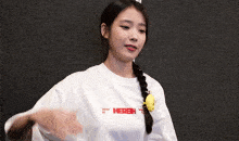a woman wearing a white shirt that says hersh on it