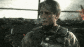 a man in a military uniform is holding a cigarette