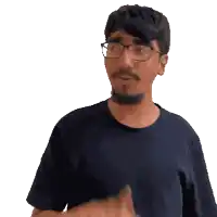 a man wearing glasses and a black shirt is pointing his finger