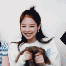 a woman is holding a stuffed animal with the word mel on it
