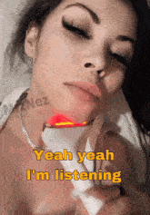 a woman is laying down with a device on her neck and the words yeah yeah i 'm listening above her