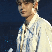 a man in a white jacket with rhinestones on it