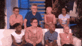 a group of people are sitting on a couch with the ellentube logo on the bottom