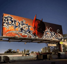 a billboard with graffiti on it that says " ummask the jokers "