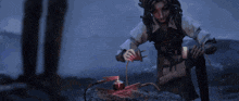 a woman is pouring something into a bottle with a red liquid