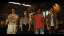 a group of people standing next to each other in a garage .