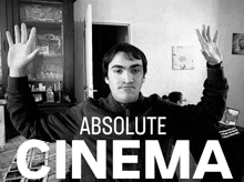 a black and white photo of a man with his hands in the air and the words absolute cinema behind him