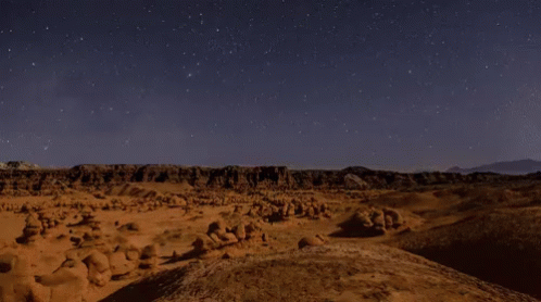A time-lapse gif of a canyon at night.