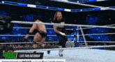two wrestlers in a wrestling ring with a money bank ad in the background