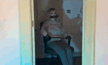 a woman is sitting in a chair with her mouth taped to the door .