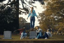a group of people are standing around a grave that says john r. cole on it