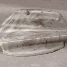 a cake is being decorated with frosting and the word mr.cakes is visible in the corner