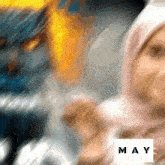 a blurred image of a woman with the word may in the corner