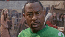 a man wearing a green jersey with the letter g on the front