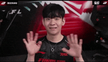 a young man wearing a shirt that says ffx is waving his hands