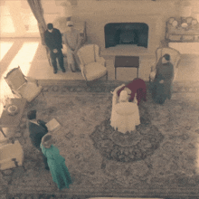 an aerial view of a living room with a woman in a white chair