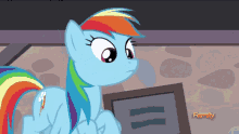 a rainbow dash from my little pony stands in front of a picture frame that says family