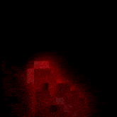 a red robot with a smiley face on his face is holding a bat in a dark room .