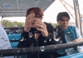 two men are riding a roller coaster with the word besty on the side