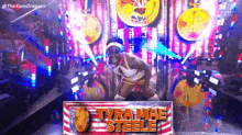 a woman is standing in front of a sign that says tyra mae steele .