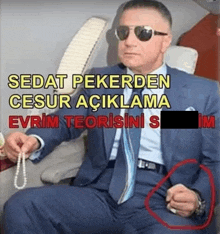 a man in a suit and tie is sitting on an airplane holding a pearl
