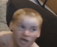 a close up of a man 's face with his mouth open and his eyes closed .