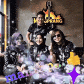 a group of people are posing for a picture in front of a sign that says megprang
