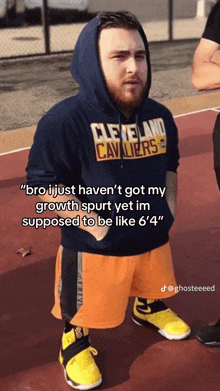 a man wearing a hoodie that says cleveland cavaliers on it