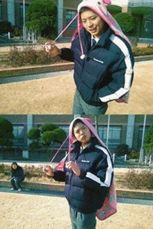 a man wearing a blue jacket and a pink hat holds a pink bag
