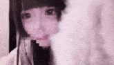 a close up of a girl 's face with a pixelated image of her mouth .
