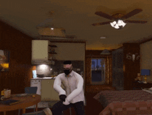 a man in a white shirt and black gloves is dancing in a room with a ceiling fan