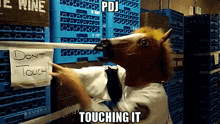 a man in a horse mask is touching a sign that says don t touch