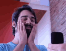 a man with a beard is looking at himself in the mirror
