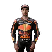 a man wearing a red bull ktm jacket and hat