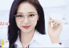 a woman wearing glasses and a white shirt has the number 3 on the bottom right