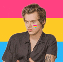 a man with a pansexual heart on his face