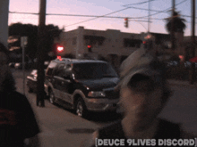 a blurry picture of a street with the words [ deuce 9 lives discord ] on the bottom