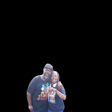 a man and a woman are posing for a picture and the man is wearing a shirt that says " be the other "