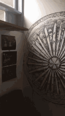 a black and white drawing of a circle on a white wall