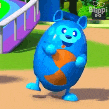 a blue cartoon character is dancing in a park while holding a beach ball .