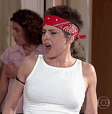 a woman wearing a white tank top and a red bandana on her head with a circle around her
