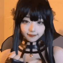 a close up of a woman wearing a black wig and a black harness .