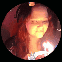 a girl blowing out a birthday candle with the word ms on the bottom right
