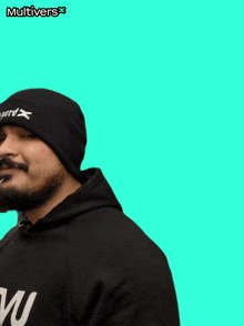 a man with a beard wearing a black beanie and a black hoodie with the word multivers on it