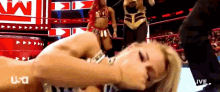 a woman is laying on the ground in a wrestling ring with the letters usa on the bottom