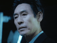 a close up of a man 's face with a black background
