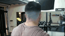 a man stands in a gym with a sign that says max on it