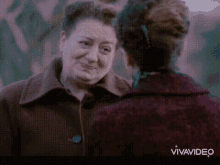 two women are standing next to each other and the words vivavideo are on the bottom of the screen