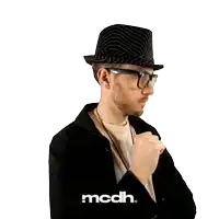 a man wearing a hat and glasses has the word mcdh on the bottom
